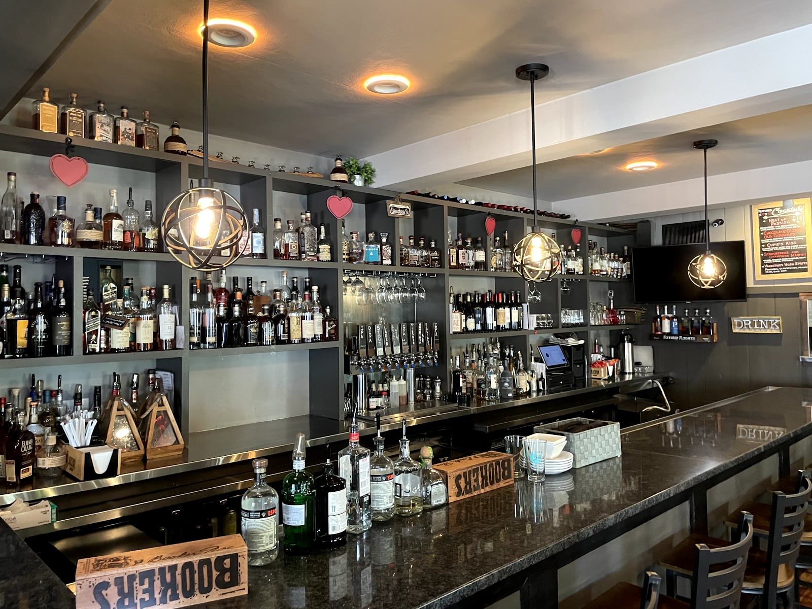 Cage pendant lights over a restaurant bar