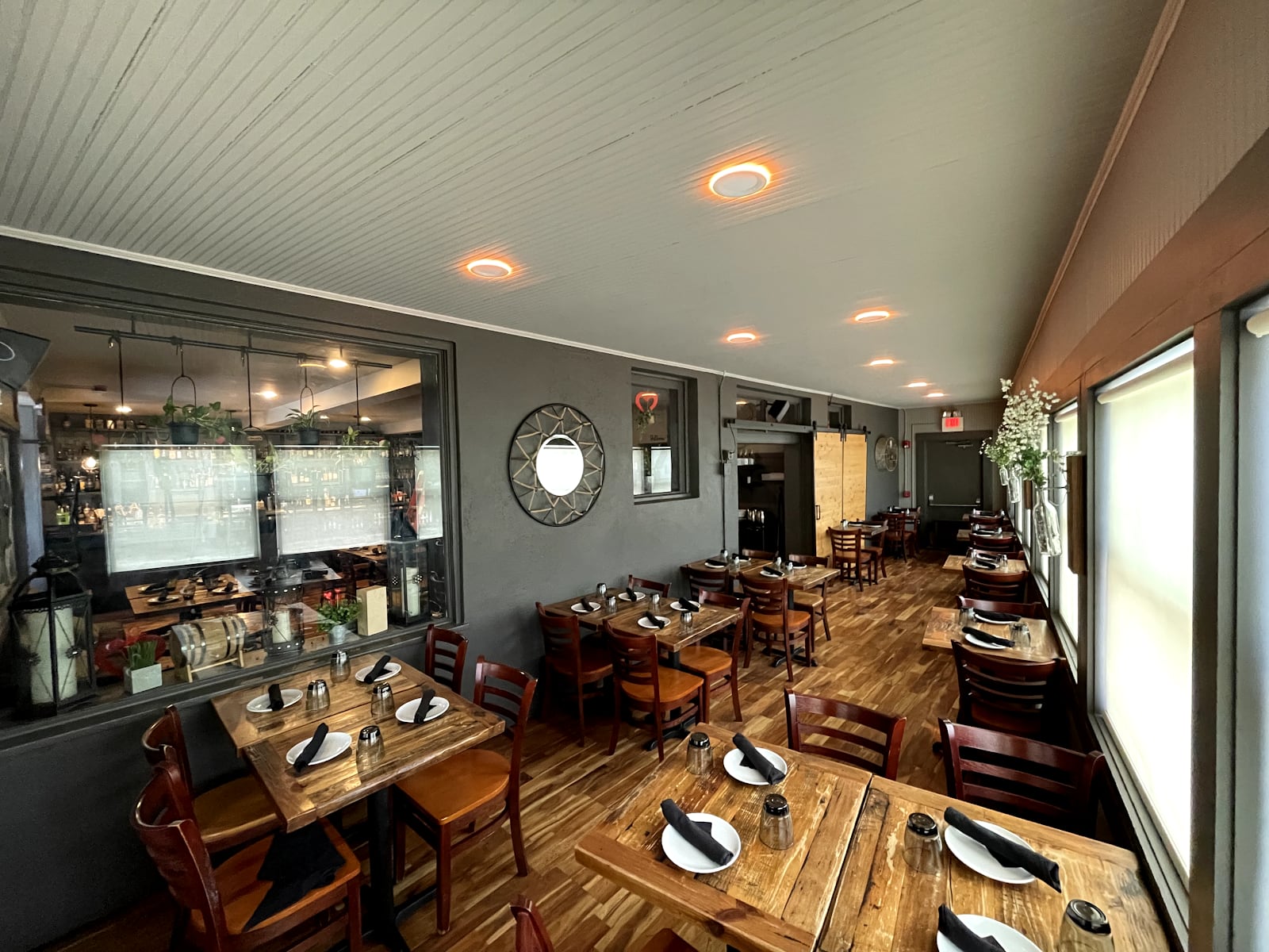 A restaurant dining room under warm recessed lights